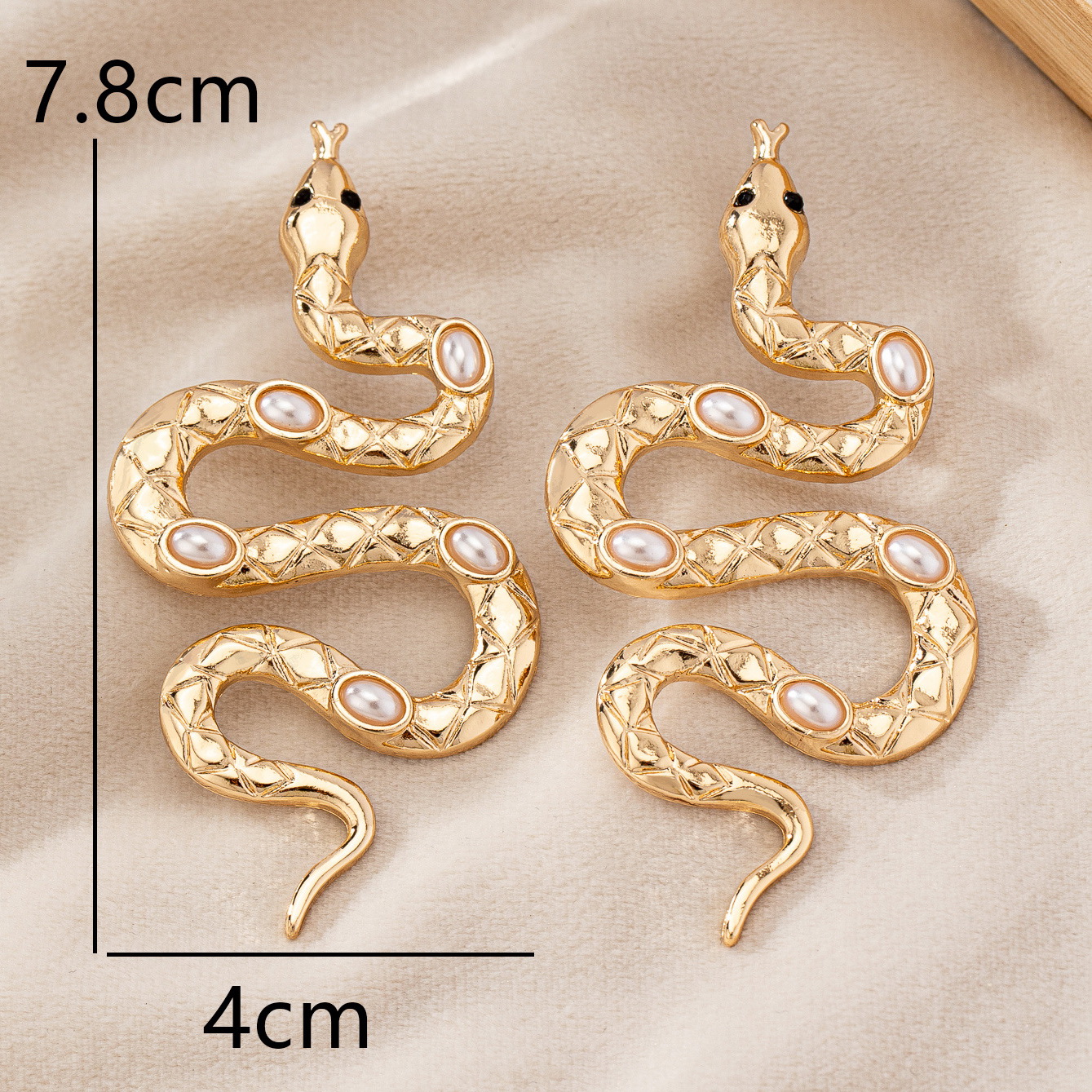 Gold snake earrings with pearl inlays for wholesale buyers