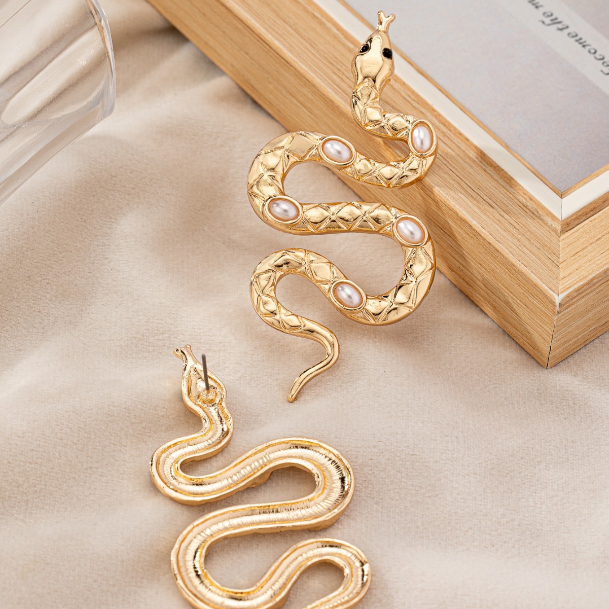 Gold snake earrings with pearl inlays for wholesale buyers