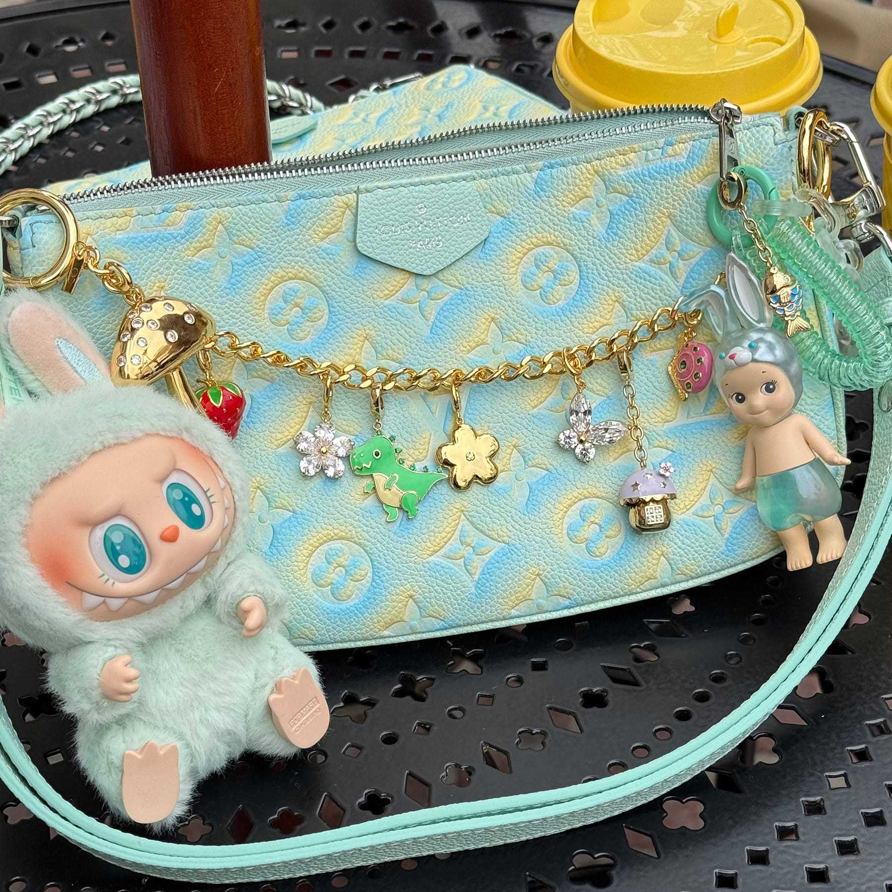 Stainless steel bag charm bracelet with strawberry, flower, and dinosaur pendants