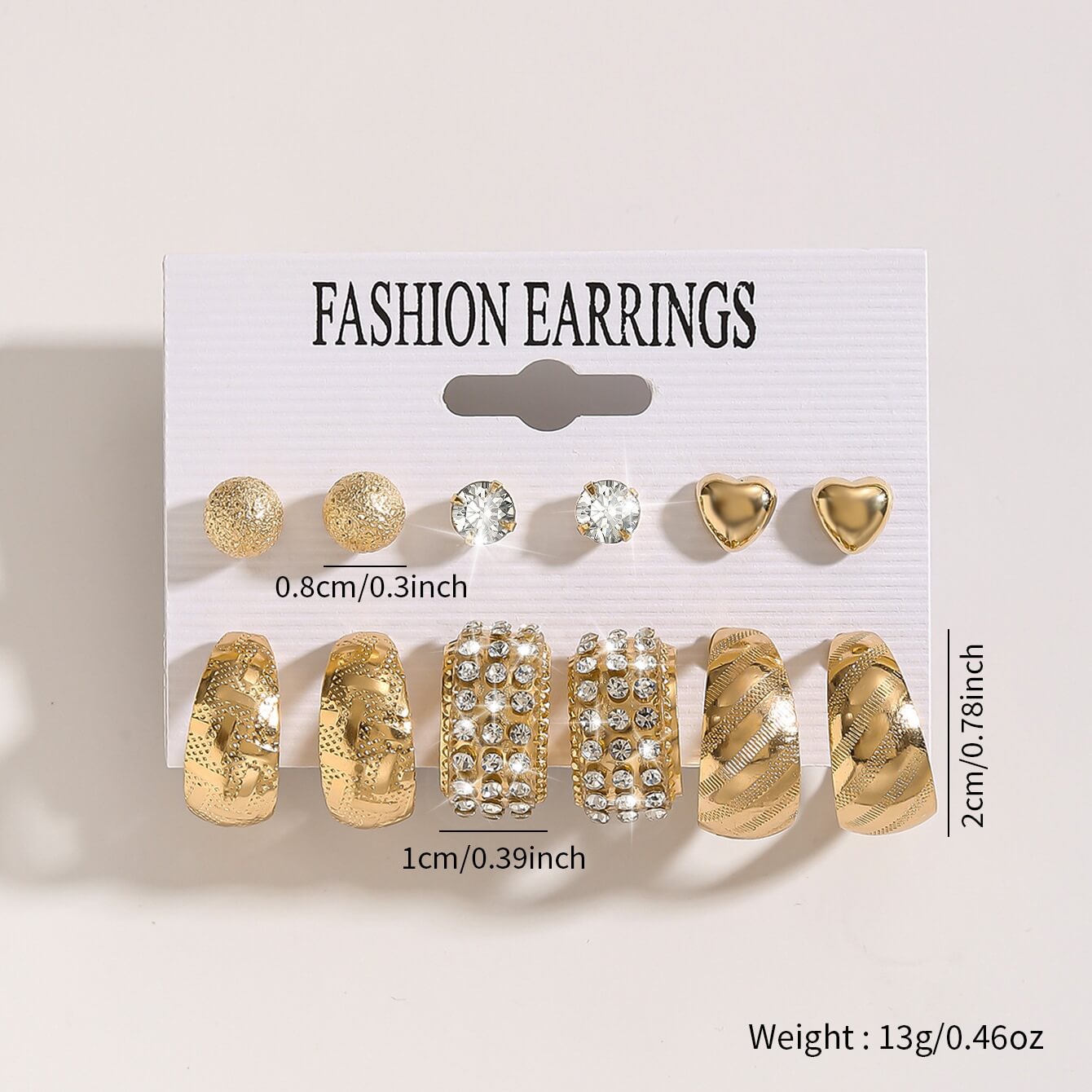 Gold hoop and stud earrings set with crystal and heart designs