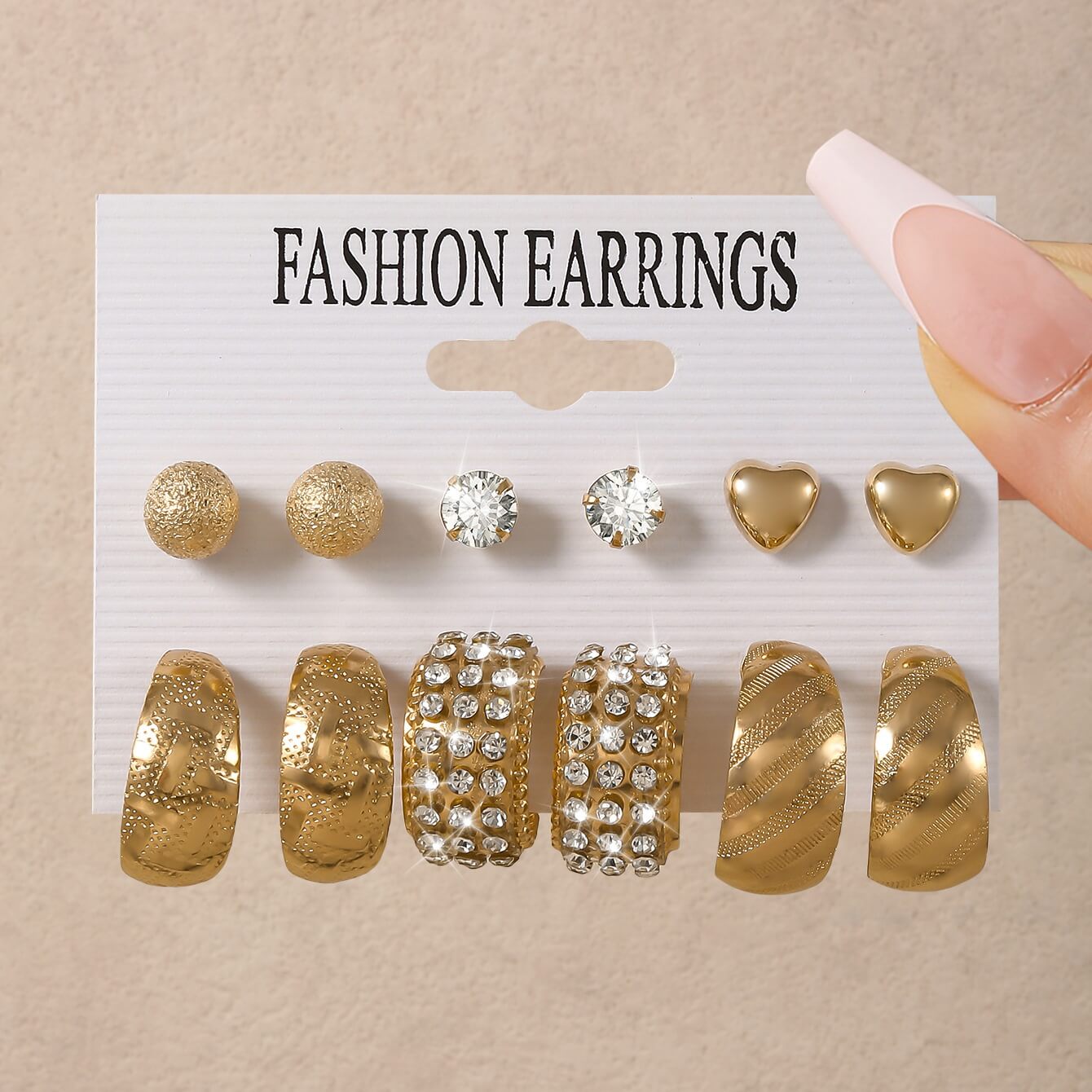 Gold hoop and stud earrings set with crystal and heart designs
