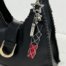 Custom metal chain lipstick holder keychain on black leather handbag